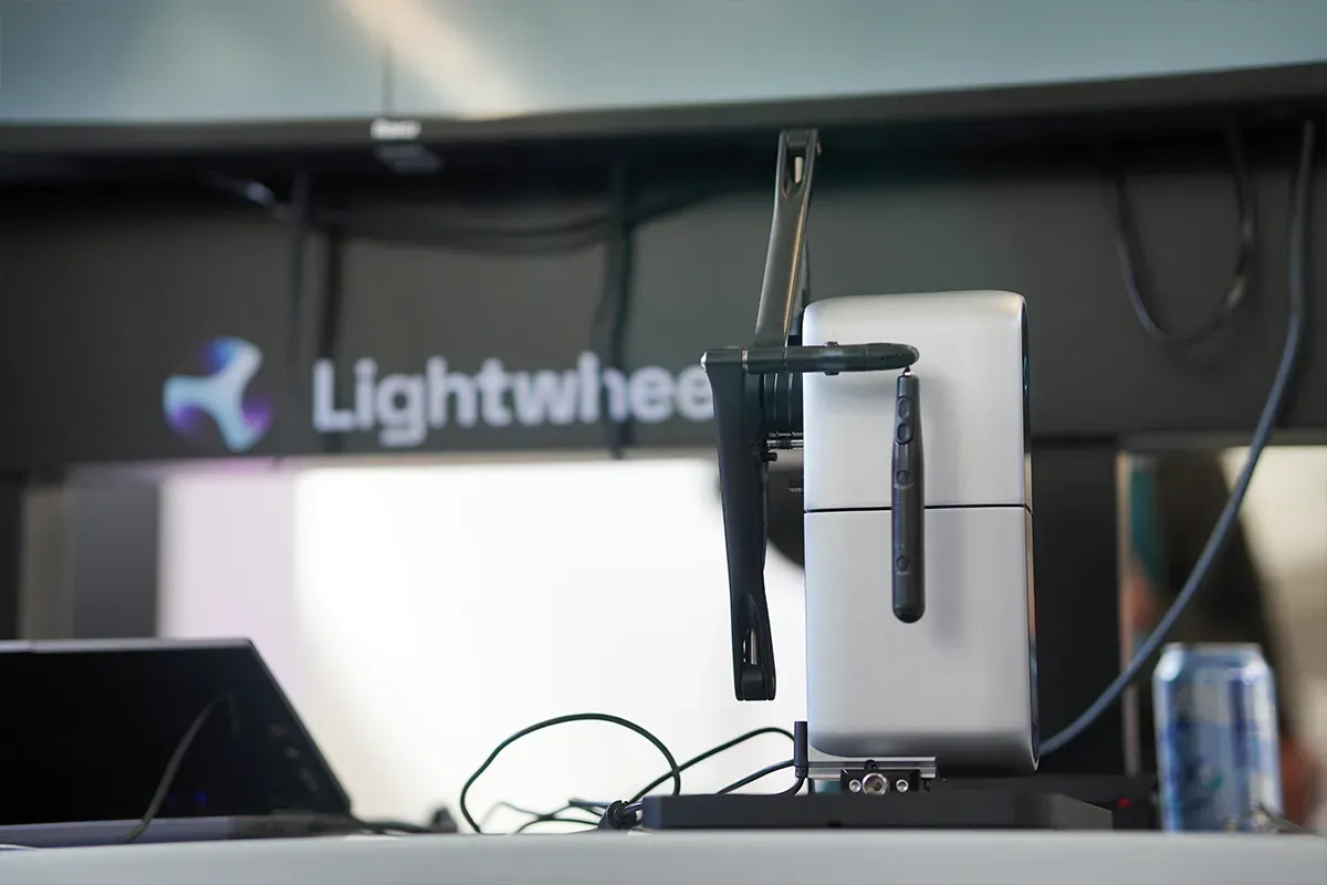 Lightwheel demonstrated its simulation-to-reality workflow with a robotic arm and a microwave oven